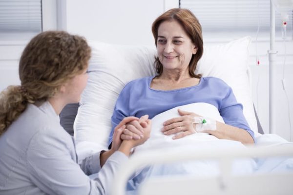 hospice myths hospice patient holds friend's hand